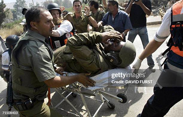 Israel-Lebanon border, ISRAEL: An injured Israeli soldier is evacuated by comrades back across the border into Israel after an incursion inside...