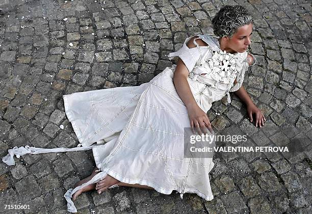 Model performs as she presents creation by Bulgarian designer Mariela Gemisheva during an open air fashion show in Sofia, 24 July 2006. AFP PHOTO /...