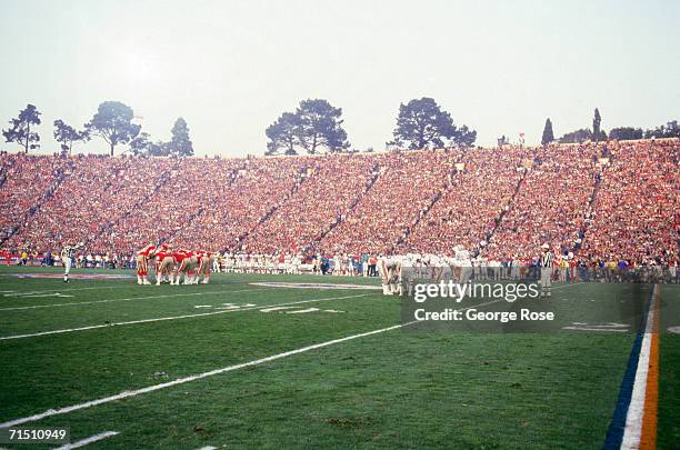 The Miami Dolphins and San Francisco 49ers huddle as they face off in Super Bowl XIX at Stanford Stadium on January 20, 1985 in Stanford, California....