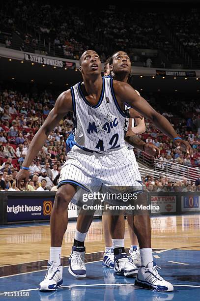 March 31: Dwight Howard of the Orlando Magic boxes out against Josh Powell of the Dallas Mavericks on March 31, 2006 at TD Waterhouse Centre in...