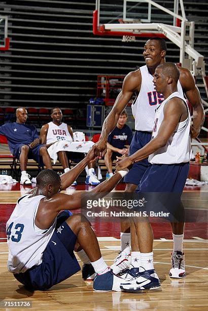 Dwight Howard and Chris Paul help Dwyane Wade up during USA Senior Mens National Team practice on July 24, 2006 at the Cox Pavilion in Las Vegas,...
