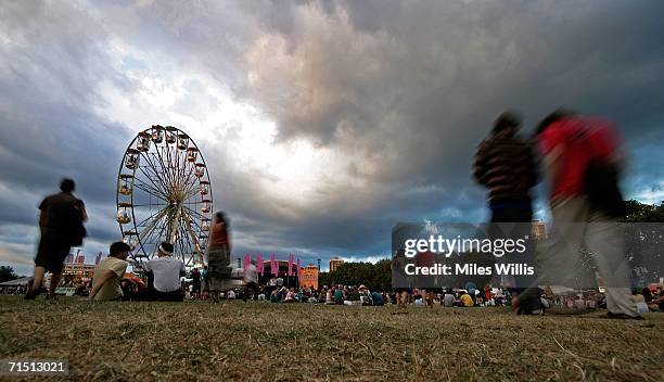 Festival go-ers enjoy the atmosphere and music during the first day of the Volvic Lovebox Weekender held in Victoria Park on July 23, 2006 in East...