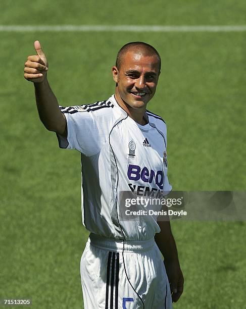 Fabio Cannavaro of Italy gestures to fans during his official presentation as a new Real Madrid signing, at the Santiago Bernabeu stadium on July 25,...