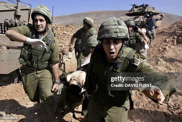 Israel-Lebanon border, ISRAEL: An injured Israeli soldier rushed back from across the border into Israel after an incursion inside southern Lebanon,...