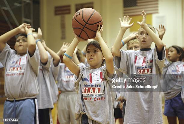 Cares summer camp participants practice their ball handling skills July 25 at Eldorado High School gym in Albuquerque, New Mexico. NBA legends...