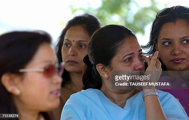 Indian war widows grieve for their fallen husbands as they take part in a memorial service in Dras, some 180kms east of Srinagar, 26 July 2006....
