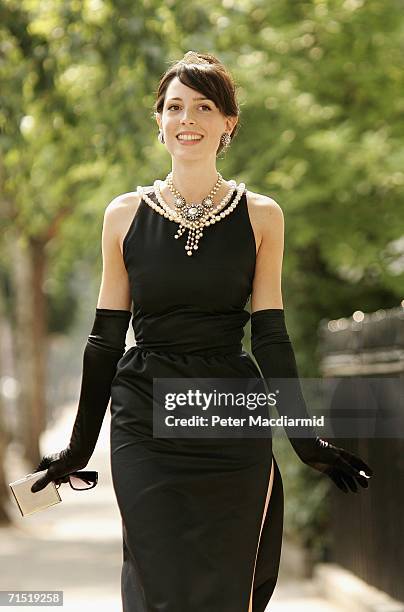 Romilly Collins from Christie's, models an original Givenchy dress worn by Audrey Hepburn in the film 'Breakfast at Tiffany's' on July 26, 2006 in...