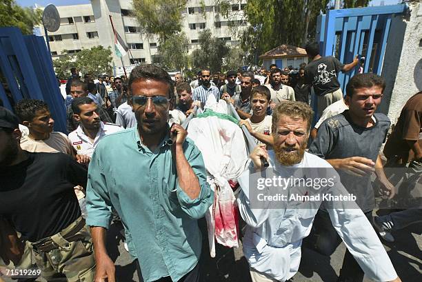 Palestinians carry the body militant during his funeral after he was killed by an Israeli air raid July 26, 2006 in Gaza City, Gaza Strip. Israeli...