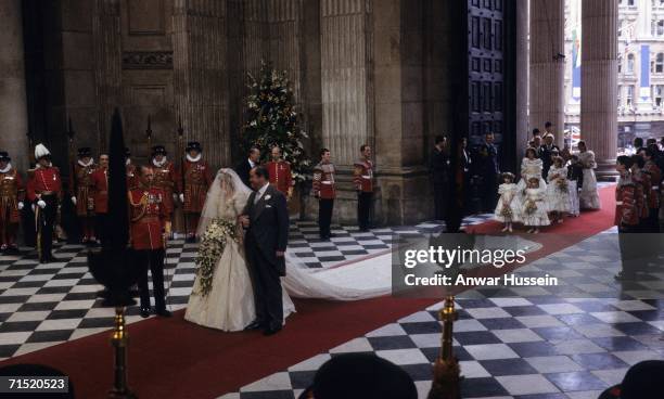 Lady Diana Spencer, wearing a wedding dress designed by David and Elizabeth Emanuel and the Spencer family Tiara, enters St. Paul's Cathedral on the...