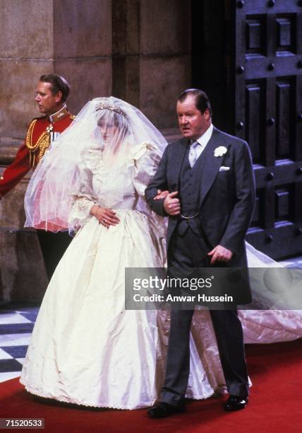 Lady Diana Spencer, wearing a wedding dress designed by David and Elizabeth Emanuel and the Spencer family Tiara, enters St. Paul's Cathedral on the...