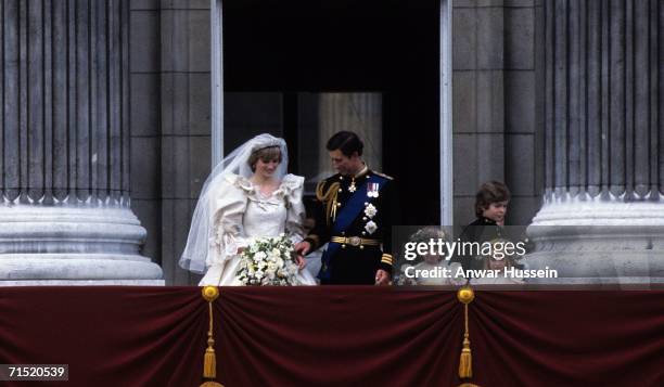 Prince Charles, Prince of Wales and Diana, Princess of Wales, wearing a wedding dress designed by David and Elizabeth Emanuel and the Spencer family...