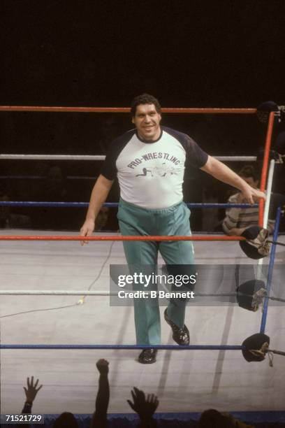 French professional wrestler and actor Andre the Giant smiles as he walks around in the ring as a special guest referee for the match with Rowdy...