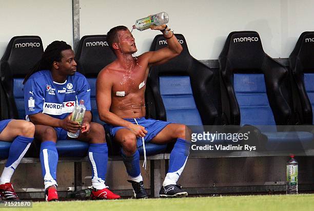 German movie star Til Schweiger refreshes as his team mate and TV presenter Mola Adebisi looks on during the 'Spiel des Herzens' benefit match for...