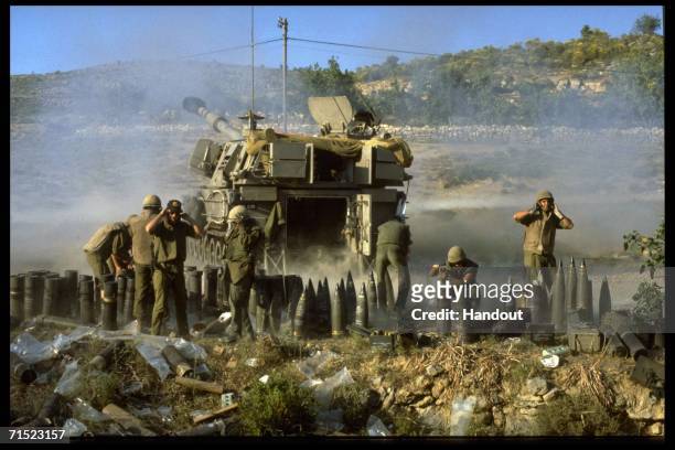 In this archive image provided by the Israeli Government Press Office , Israeli artillery soldiers fire shells at targets during Israel's Peace For...