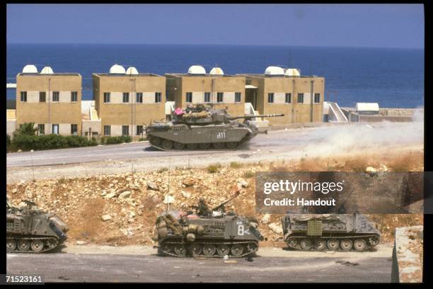 In this archive image provided by the Israeli Government Press Office , Israeli armor partrol the coastal road during Israel's Peace For Galilee...