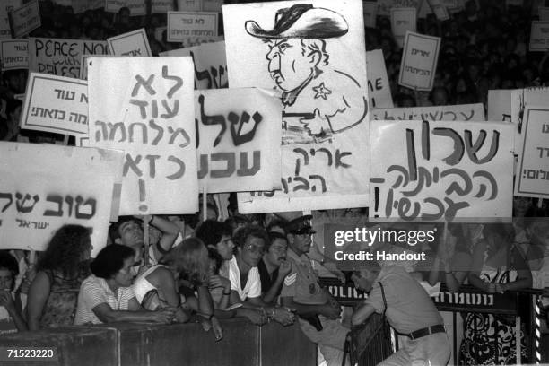 In this archive image provided by the Israeli Government Press Office , Israeli anti-war protestors demonstrate with a caricature of Defense Minister...