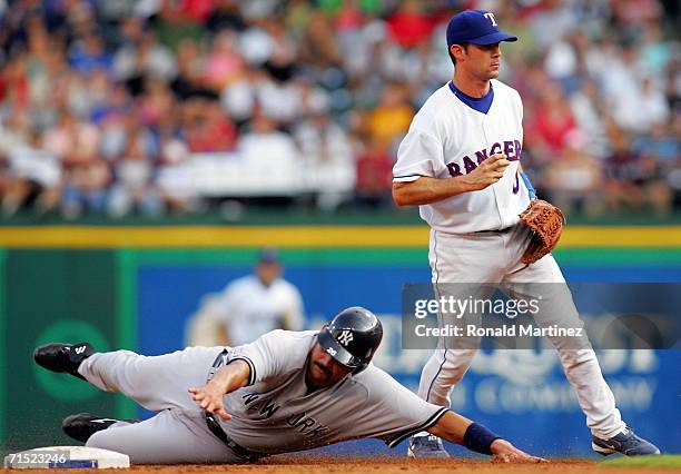 Shortstop Michael Young of the Texas Rangers steps off the base after making the force out against Sal Fasano of the New York Yankees on July 26,...