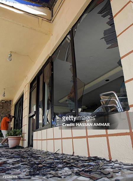 Photographer takes pictures of a damaged restaurant after an Israeli airstrike which targeted a flat in the building in the southern Lebanese port...