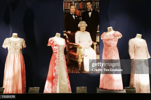 Dresses by Sir Norman Hartnell, John Anderson and Stewart Parvin designed for Queen Elizabeth II at an exhibition her dresses in the State Rooms of...