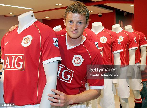 Ole Gunnar Solskjaer of Manchester United poses in the new home shirt at the Official launch of the new Manchester United home kit in the Megastore...