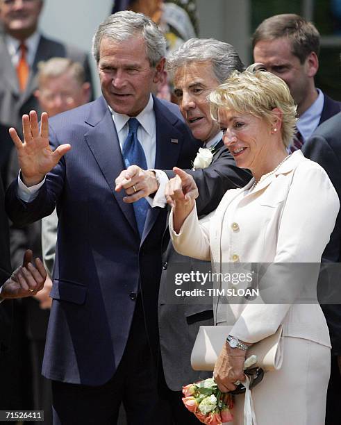 Washington, UNITED STATES: US President George W. Bush talks with John Walsh and Walsh's wife Reve before the Signing of H.R. 4472, the Adam Walsh...
