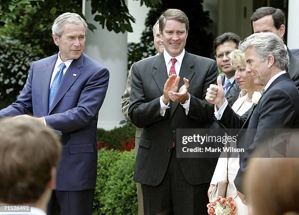 John Walsh gives a thumbs up while U.S. President George W. Bush intorduces him and his wife Reve Walsh while Senate Majority Leader Bill Frist...