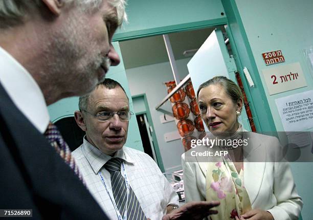 Finnish Foreign Minister Erkki Tuomioja stands with EU commissioner Benitta Ferrero Waldner as they listen to an official during a visit in Rambam...