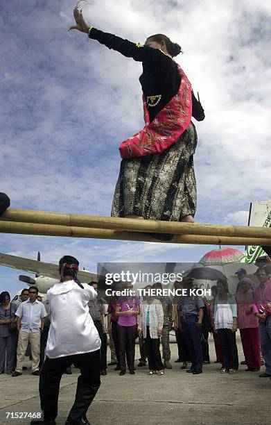 Filipina dancer performs a traditional tribal Muslim dance on a bamboo pole during the arrival welcome ceremony for US Ambassador to the Philippines...
