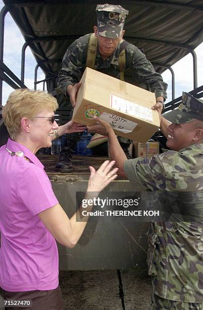 Ambassador to the Philippines Kristie Kenny inspects Philippine Marines unloading a delivery of US school books for distribution to several schools...