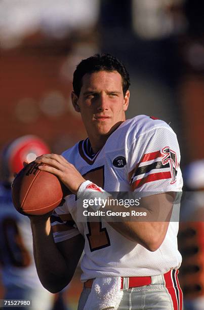 Quarterback Hugh Millen of the Atlanta Falcons warms up on the sidelines during a game against the Los Angeles Raiders at Los Angeles Memorial...