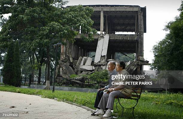 Elderly residents of Tangshan Mr and Mrs Guo sit in front of the preserved earthquake ruins on the campus of Hebei Polytechnic University in central...