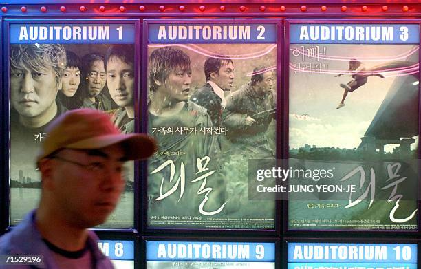 South Korean man walks past posters promoting the monster film "The Host" at a theater in downtown Seoul, 28 July 2006. "The Host", directed by Bong...