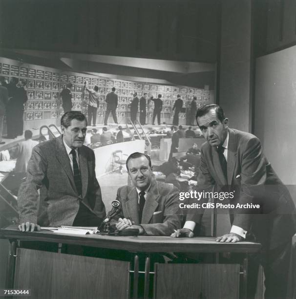 News reporters Eric Sevareid, Walter Cronkite and Edward R. Murrow pose by a news desk. Image dated October 9, 1958. Advance art for CBS News...