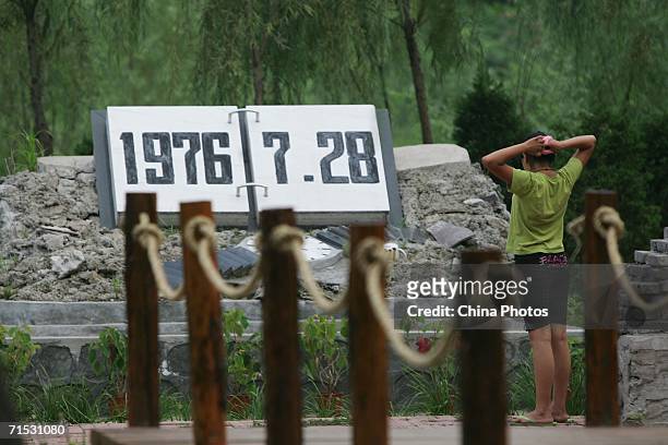 Visitor views the ruins of a building with a memorial dedicating the date of the Tangshan Earthquake, to mark the 30th anniversary of Tangshan...