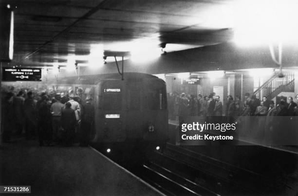 Large numbers of people using the underground system to get around London during a period of heavy smog, which hampered transport on the roads, 8th...