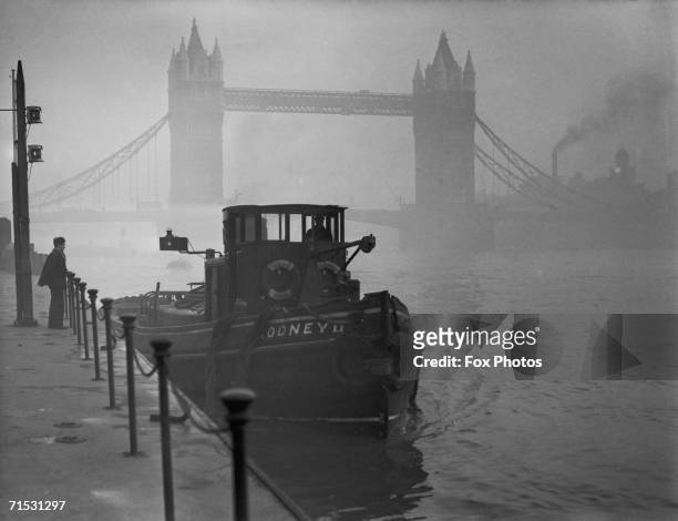 Tugboat on the Thames near Tower Bridge in heavy smog, 1952.