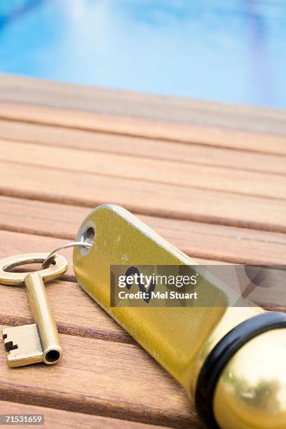 hotel room key by swimming pool, close-up - hotel key stock pictures, royalty-free photos & images