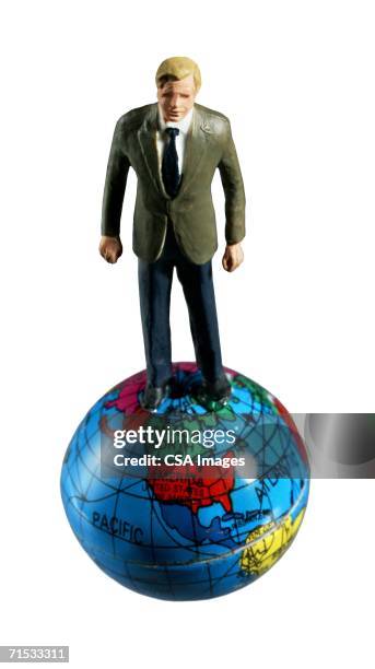 man standing on top of the world - businessman figurine stock pictures, royalty-free photos & images