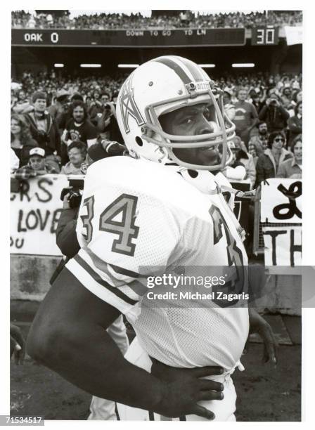 Running back Earl Campbell of the Houston Oilers stands on the sideline during the 1980 AFC Wild Card Playoff Game against the Oakland Raiders at...