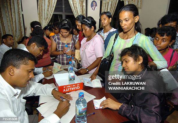 Sri Lankan domestic helpers working in Lebanon return home 29 July 2006 in Colombo. Some 335 Sri Lankans returned home in line with an evacuation...