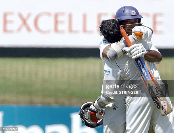 Sri Lankan cricket captain Mahela Jayawardene is hugged by teammate Kumar Sangakkara after scoring 300 during the third day of the first Test match...
