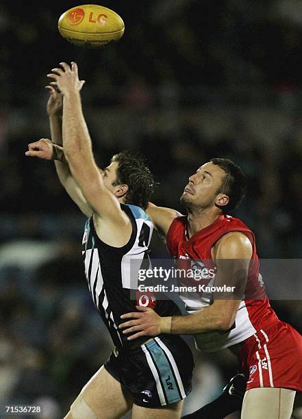 Nick Malceski of the Swans spoils Josh Mahoney of Port during the round 17 AFL match between the Port Adelaide Power and the Sydney Swans at AAMI...