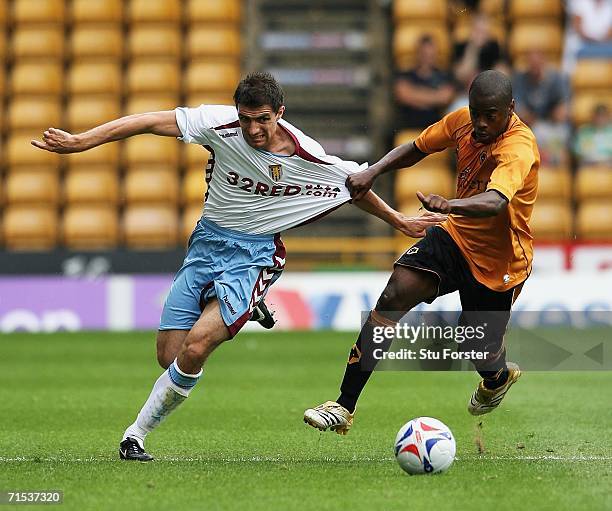 Aston Villa full back Aaron Hughes tussles for the ball with Wolves winger Rohan Ricketts during the Pre-season friendly match between Wolverhampton...