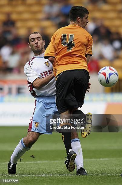 Aston Villa midfielder Gavin McCann tussles for the ball with Wolves player Kevin O'Connor during the Pre-season friendly match between Wolverhampton...