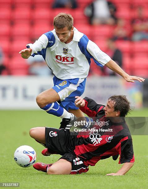 Matthew Taylor of Portsmouth is tackled by Steven Foley of Bournemouth during the pre-season friendly match between AFC Bournemouth and Portsmouth at...