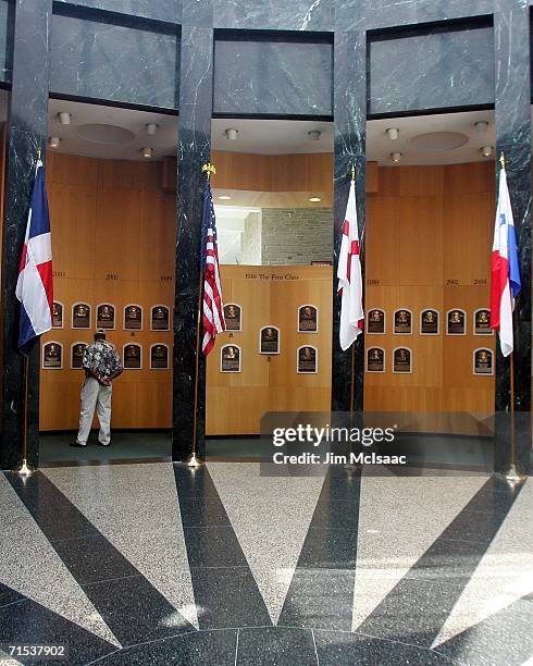 Baseball fan looks at the plaques of players inducted into the National Baseball Hall of Fame and Museum during the Baseball Hall of Fame weekend on...