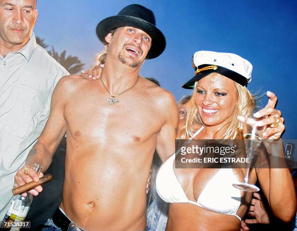 Canadian actress Pamela Anderson shares a drink with her husband, US musician Kid Rock , the day of their wedding, on Pampelone's beach in...