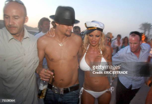 Canadian actress Pamela Anderson shares a drink with her husband, US musician Kid Rock , the day of their wedding, on Pampelone's beach in...