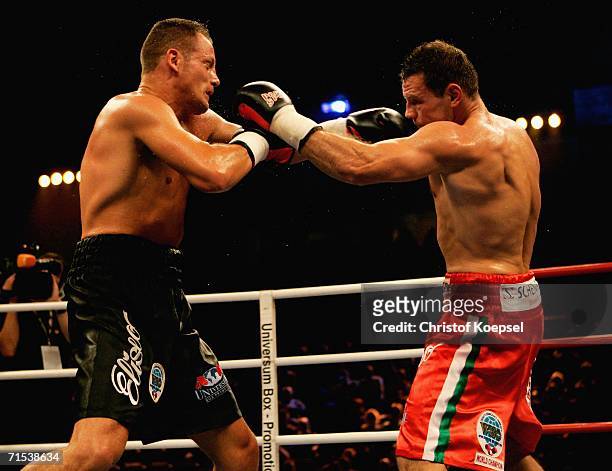 Zsolt Erdei of Hungary boxes Thomas Ulrich of Germany during the WBO Light Heavyweight Title fight at the Koenig-Pilsener Arena on July 29, 2006 in...