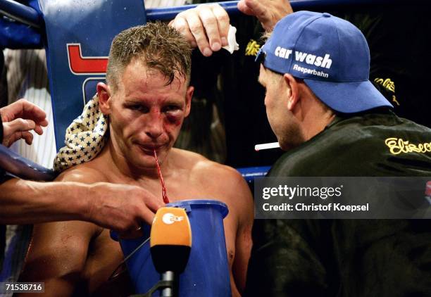 Thomas Ulrich of Germany spits blood during the WBO Light Heavyweight Title fight against Zolt Erdei of Hungary at the Koenig-Pilsener Arena on July...